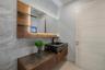 Sophisticated first-floor powder room featuring a dramatic stone vessel sink, floating custom vanity, textured designer wallcovering, and an illuminat