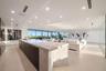 Spectacular third-floor sky lounge anchored by a dramatic illuminated onyx bar, expansive entertaining areas, and walls of glass opening to the terrac
