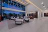 Dramatic double-height living room at twilight, featuring soaring walls of glass, expansive waterfront views, sophisticated designer finishes, integra