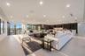 Entire third level conceived as a private entertainment destination, combining an expansive sky lounge, illuminated onyx bar, dual wine storage, and a