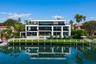 Magnificent waterfront estate commanding 125 feet of deep-water frontage on an exceptionally wide canal, featuring a spectacular 75-foot infinity-edge