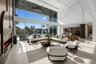 Expansive open-concept living space with soaring ceilings, walls of glass, custom architectural details, and effortless indoor-outdoor living.