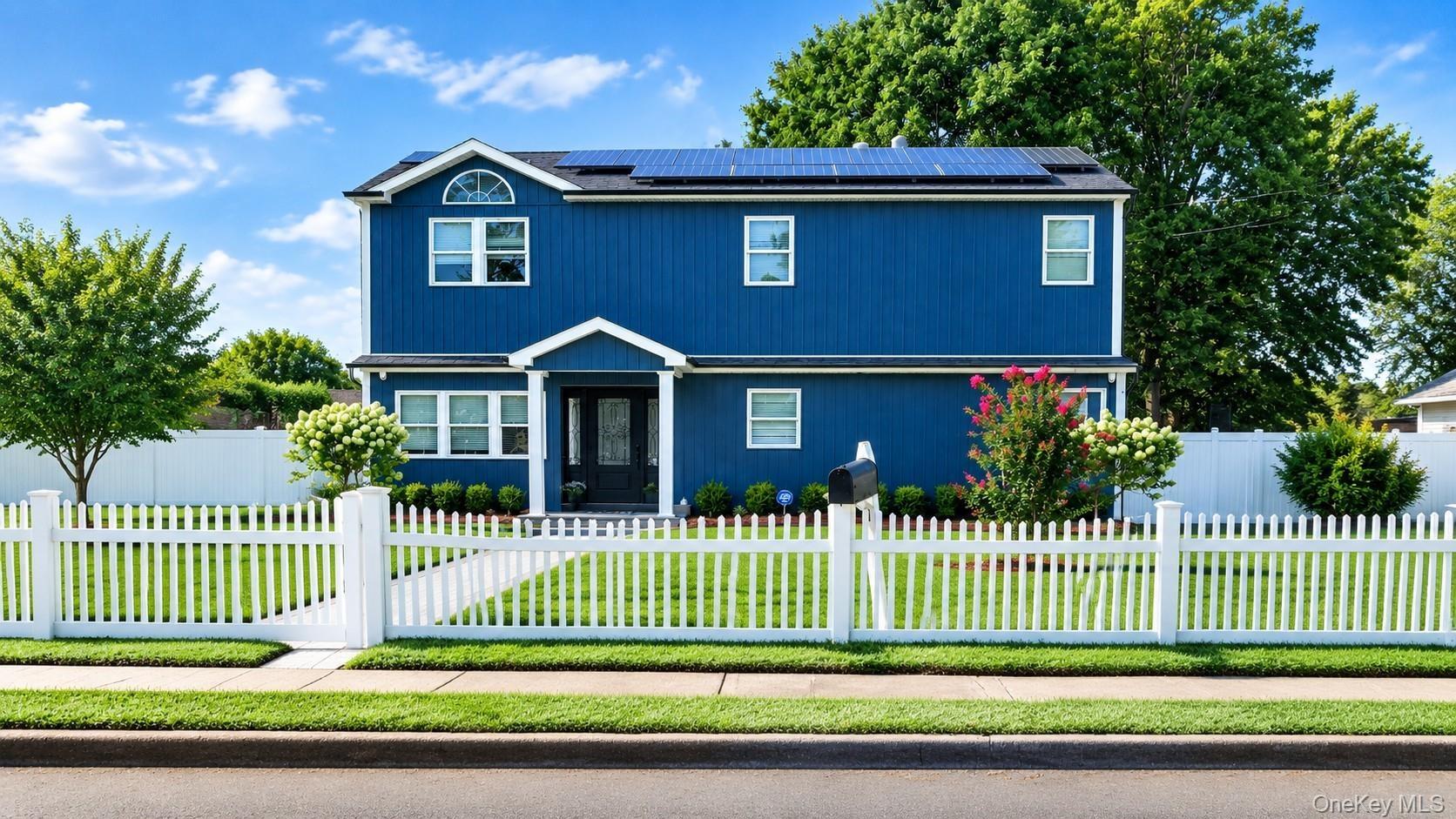 Two-story residence featuring a new exterior siding, trim details.