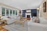 Large living room with bay window and wood buring fireplace