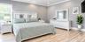 Spacious Bedroom with a new full bath. Neutral wall color, crown molding, new finished flooring, recessed lighting, and a big window