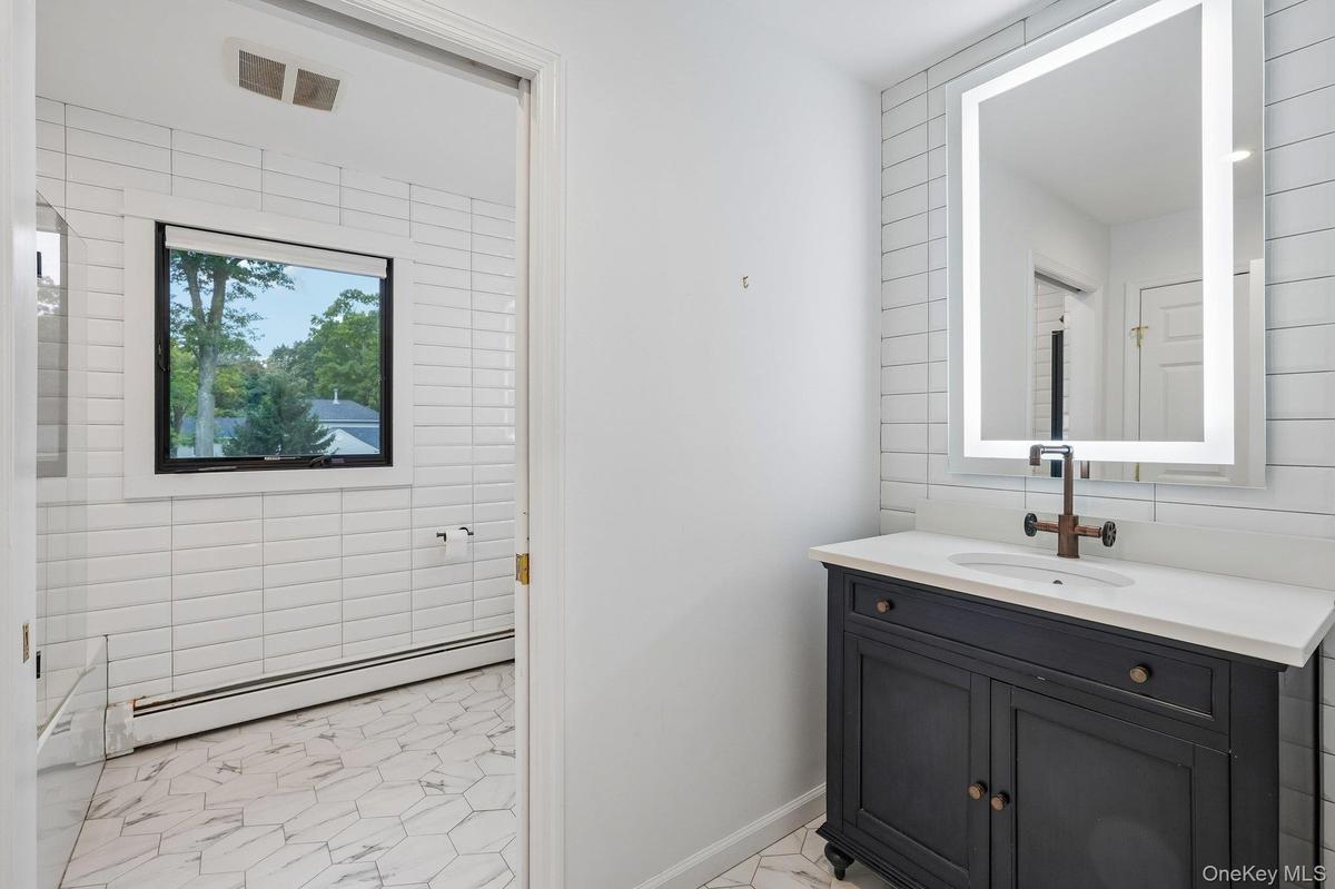 Main bathroom with pocket door partition from toilet & tub