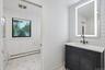 Main bathroom with pocket door partition from toilet & tub