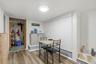 MAIN HOUSE - Laundry and storage area with a washer, dryer, shelving and utility space.