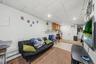 APARTMENT - Living area with an open view into the kitchen and dining space.