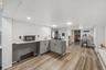 MAIN HOUSE - Another kitchen angle showing the center island, windows and open workspace.