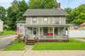 Full front view highlighting the home’s traditional character and expansive covered porch.