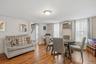 MAIN HOUSE - Dining area with wood-look flooring, multiple windows and access to the adjoining rooms.
