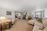 MAIN HOUSE - Additional view of the living room, featuring a fireplace and access to the adjoining room.