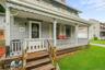 A closer look at the covered front porch; an inviting outdoor space ready for restoration and personal touches.