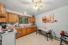 APARTMENT - Eat-in kitchen with wood cabinetry, counter space and a window overlooking the yard.