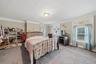 MAIN HOUSE - Spacious primary bedroom with room for multiple furniture arrangements.