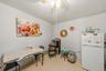 APARTMENT - Another kitchen angle showing the dining area and appliance space.
