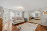MAIN HOUSE - Flexible sitting and dining area with multiple windows and a wide opening to the adjoining living room.