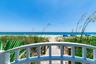 Gated beach access leads to sandy white beaches where you can relax in a covered cabana