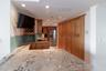 open kitchen with breakfast bar and TV to enjoy the morning news