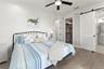 Primary Bedroom with Large Walk-In Closet and Barn Door to Bathroom