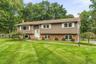 Split-level residence featuring a brick foundation and siding exterior
