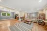 Hardwood-style flooring throughout, recessed lighting, and a pendant light fixture