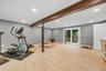 Recessed lighting and light wood-finish flooring complement the neutral wall tones