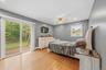 Sliding glass door leading to an outdoor deck, recessed lighting, wood-finish flooring, and a ceiling fan with integrated lighting