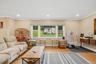Recessed lighting, crown molding, wood-finish flooring, a large picture window, and a built-in wall console