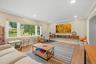Recessed lighting, crown molding, wood-finish flooring, large picture window, and custom floating media console