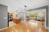 Wood-finish flooring throughout, with a kitchen island featuring wood cabinetry