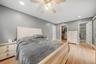Hardwood flooring, recessed lighting, ceiling fan, walk-in closet, and an attached bathroom with a tiled shower