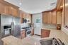 Granite countertops, updated applianced, natural gas cooking, outside separate entrance leads to side/rear fenced yard.