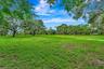 Expansive green space featuring mature trees and open areas