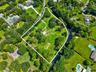 Expansive lot featuring mature trees, a natural water feature, and substantial green space