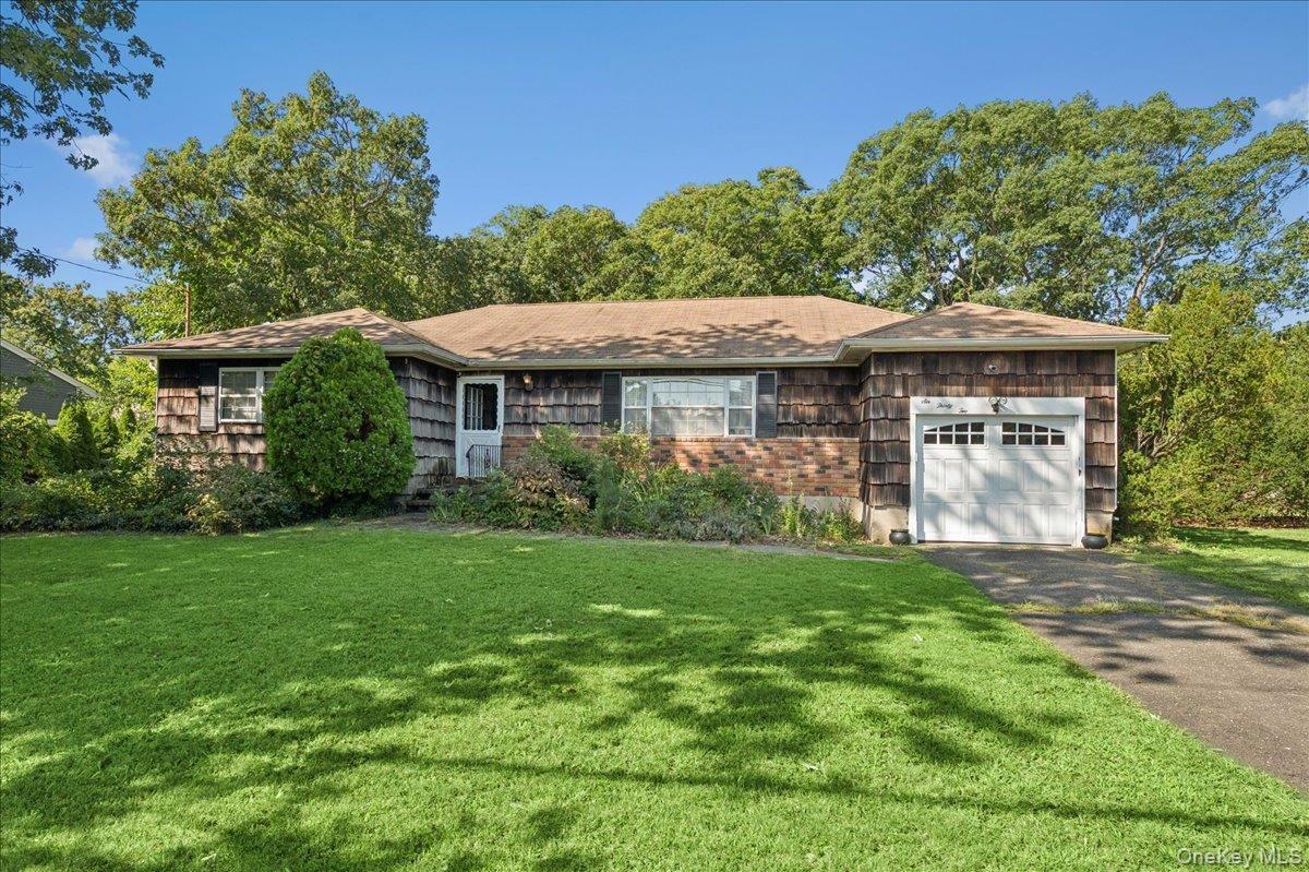 Ranch-style exterior with wood shingle siding and brick accents
