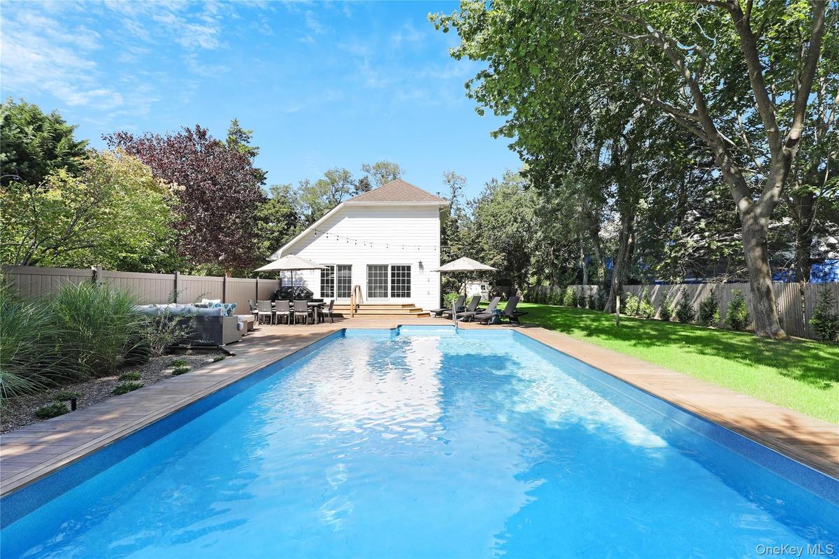 View of swimming pool with a fenced backyard, outdoor dining space, a patio, and an outdoor living space