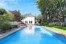 View of swimming pool with a fenced backyard, outdoor dining space, a patio, and an outdoor living space