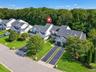 Aerial view of unit with attached one car garage and long driveway