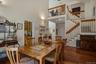 A dramatic first impression is created by the vaulted ceilings and open floor plan, which give the home a spacious and inviting feel.