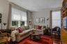 The den features custom built-ins and new double hung windows overlooking both the front and side of the home filling the room with natural light.