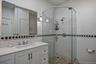 The primary bathroom features a standalone shower and double vanity.
