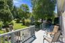 Another view of the deck showcases the landscaped yard and exceptional privacy.