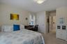 Another angle of bedroom with convenient access to the updated Jack-and-Jill bathroom.