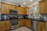 The kitchen features stainless steel appliances, granite countertops and durable ceramic-tile flooring.