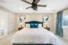 Carpeted bedroom featuring a ceiling fan and recessed lighting