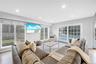 Living room with light wood finished floors and recessed lighting