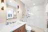 Bathroom featuring vanity, walk in shower, and recessed lighting