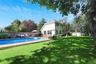 View of swimming pool featuring outdoor lounge area, a fenced backyard, an outdoor structure, and a patio